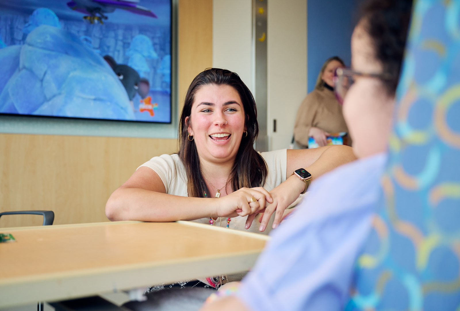 Specialist smiling and talking with pediatric patient
